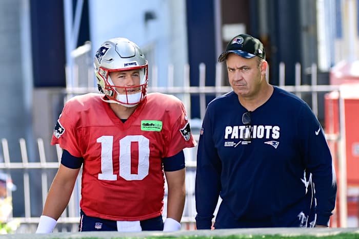 Mac Jones walks next to Bill O’Brien, talking